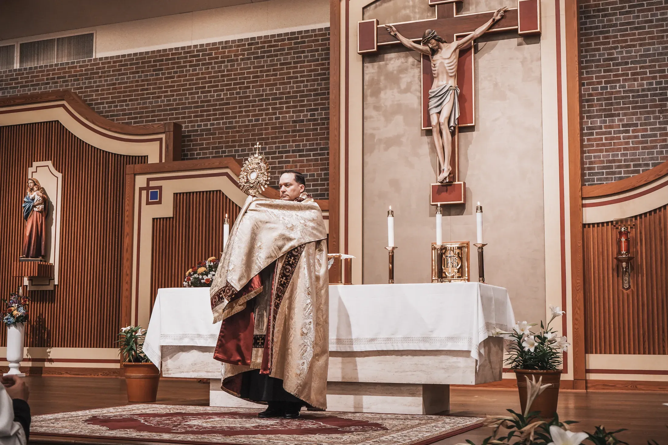 Priest holding a monstrance before the altar