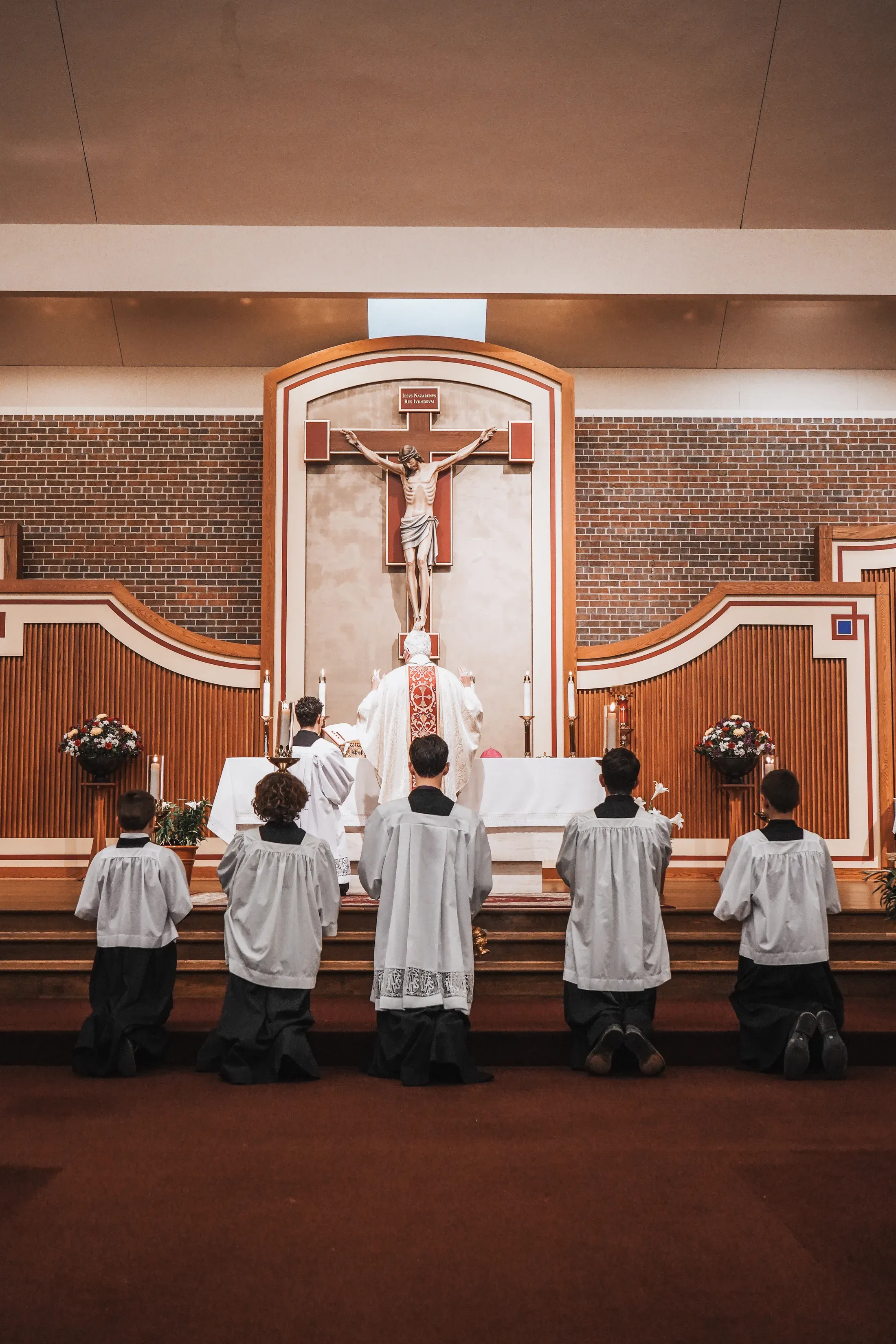 Priest and altar servers facing the crucifix and altar