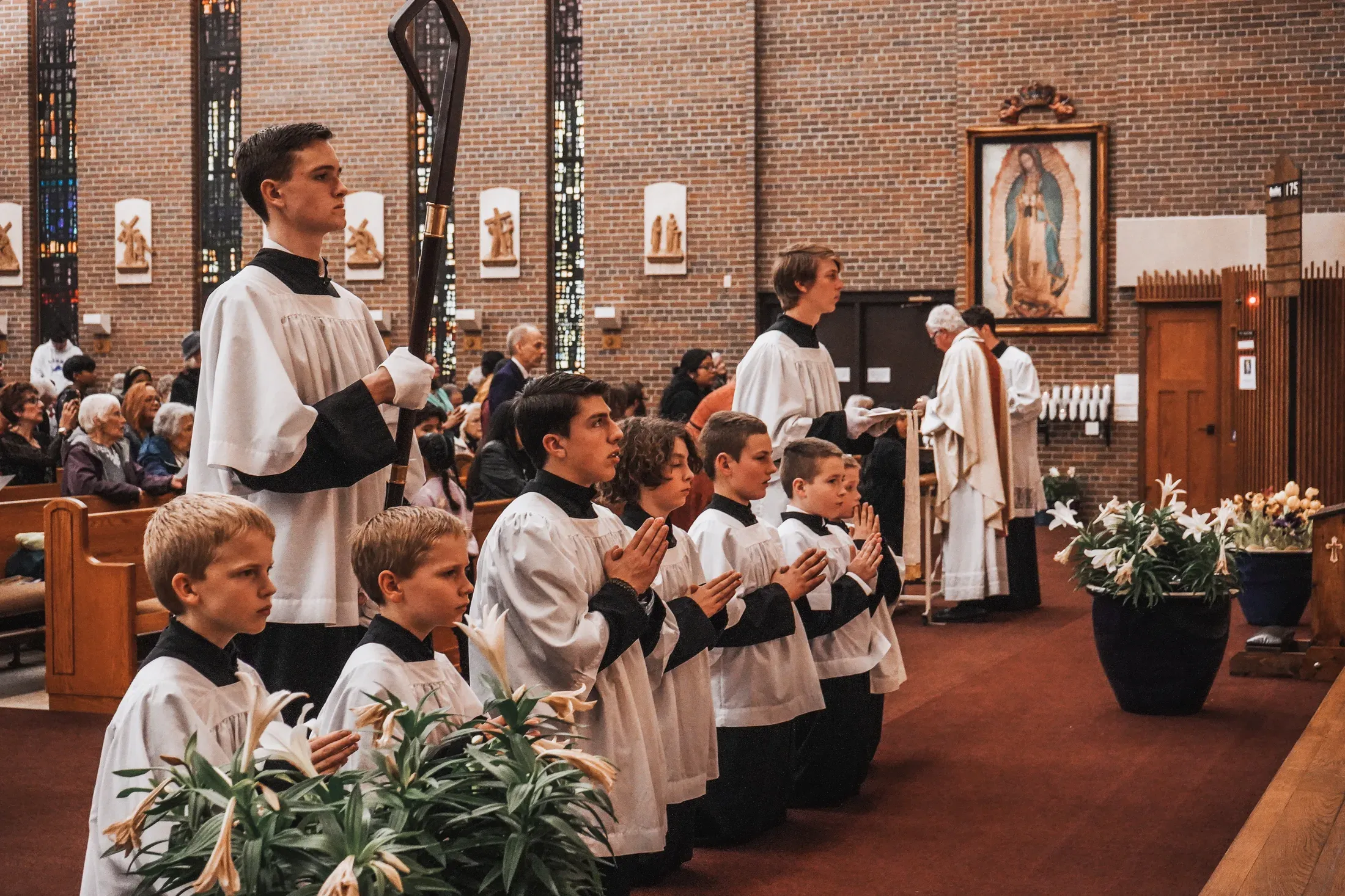 Altar servers and parishioners gathered in prayer